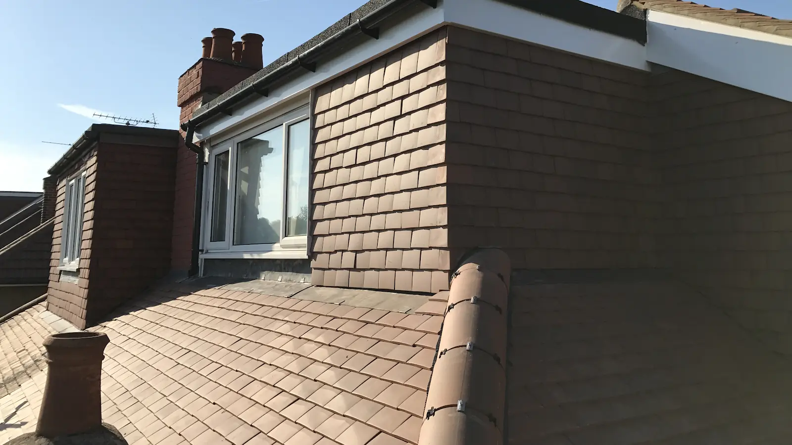 Tiled dormer, ridge tiles and gutters on a house roofed by R Spiers Roofing
